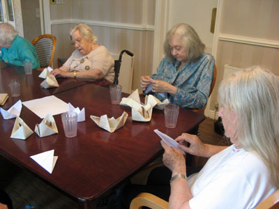 The residents have a go at creating some origami boats!
